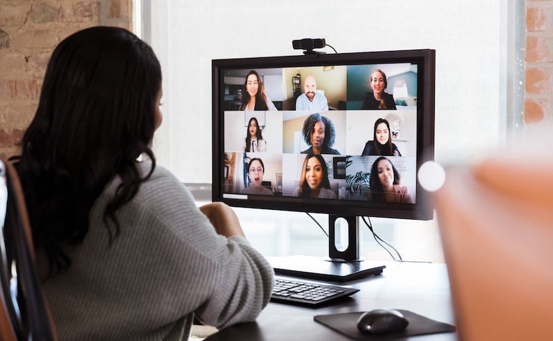 Businesswoman Meets With Colleagues During Virtual Staff Meeting