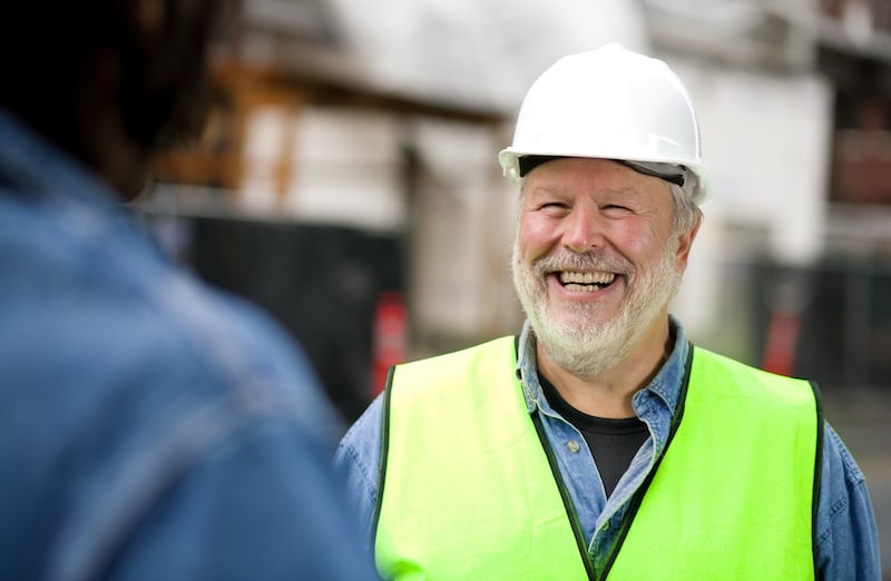 Photo Of Smiling Bearded Construction Worker In Green Vest