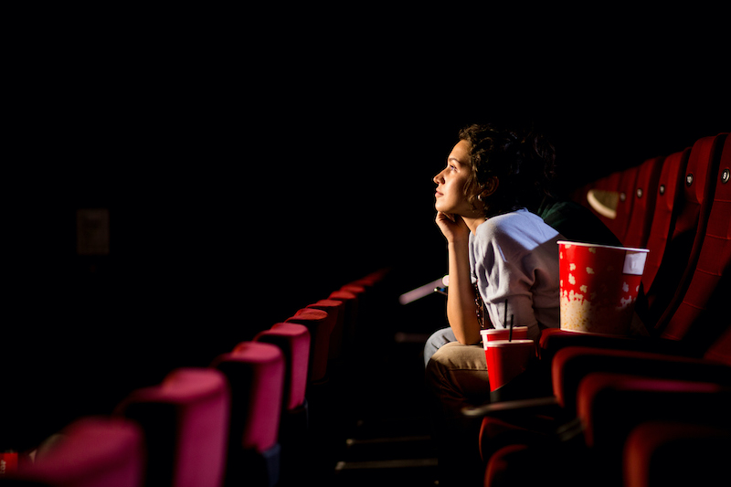 Young Woman Enjoying Watching Movie At The Cinema