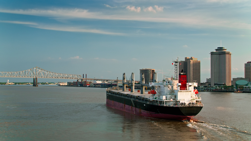 Drone Shot Of Bulk Carrier Traveling Up The Mississippi Past New Orleans