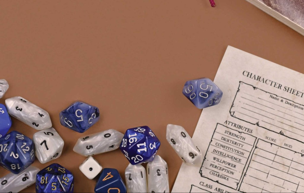 Flat Lay Concept Design For Tabletop Role Playing With Colorful Blue And White Rpg Dices, Character Sheet And Rule Books With Empty Copy Space On Brown Background