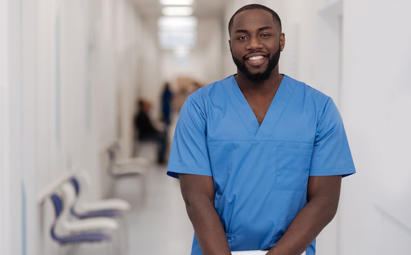 Young African American Man Standing And Smiling In The Hospital