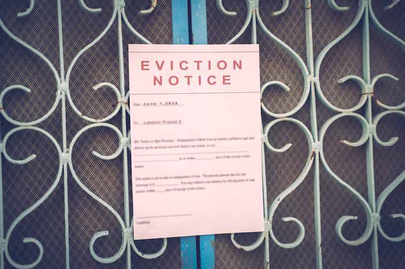 Foreclosed Or Eviciton Notice On A Main Door With Blurred Details Of A House With Vintage Filter.
