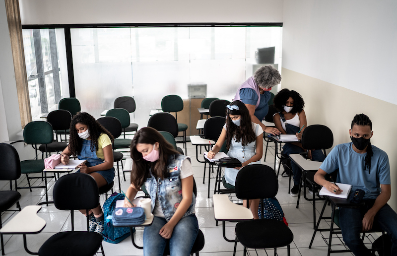 Students Wearing Face Mask Studying During Class At School