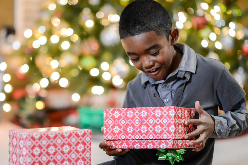 Little Boy Opening A Present