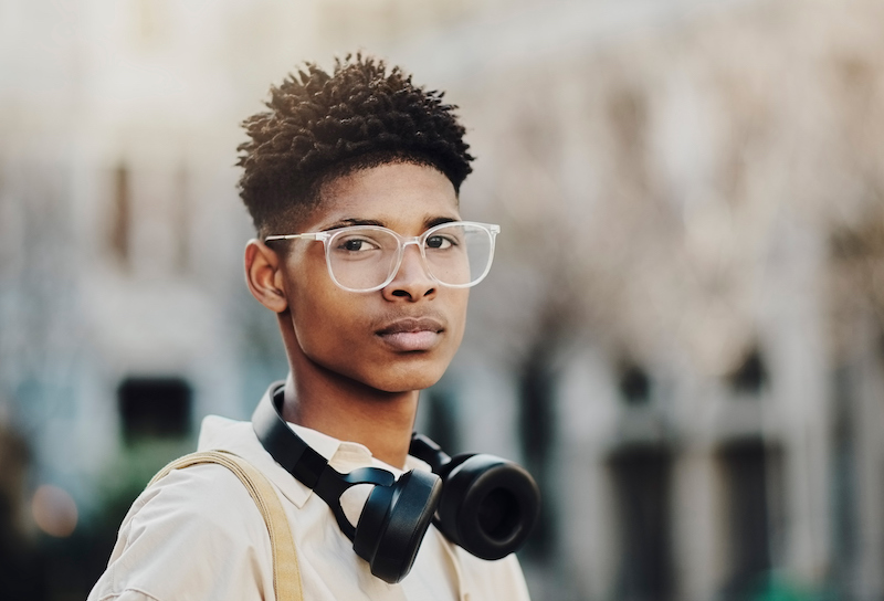 Black Man, Music Headphones And Fashion Glasses For Vision, Eye Care Or Eyesight In Jamaican City. Portrait, Student Or Tourist With Style, Trend Or Cool Clothes And Radio, Podcast Or Audio Equipment