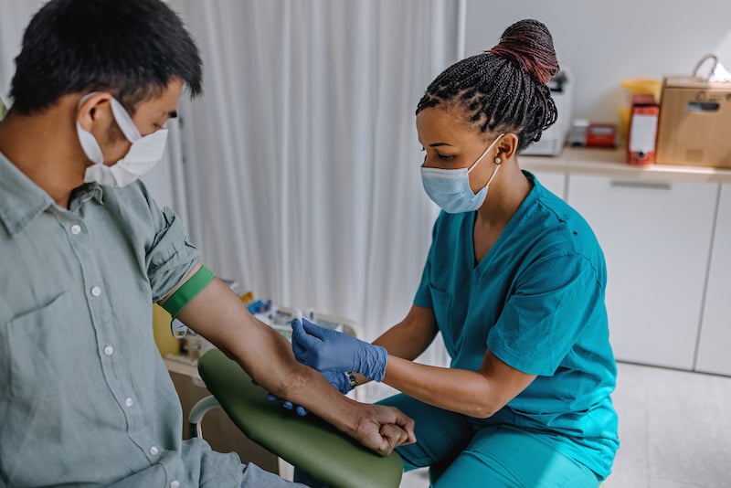 Nurse Preparing Patient To Do A Blood Analysis