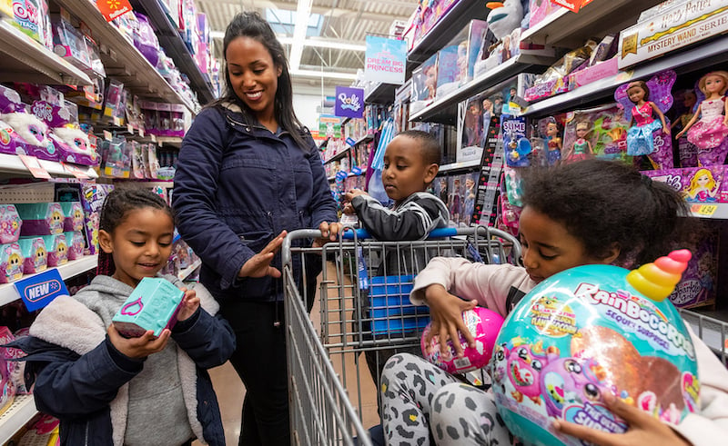 A Family Checks Out New Holiday Toys In A Walmart Store Aisle
