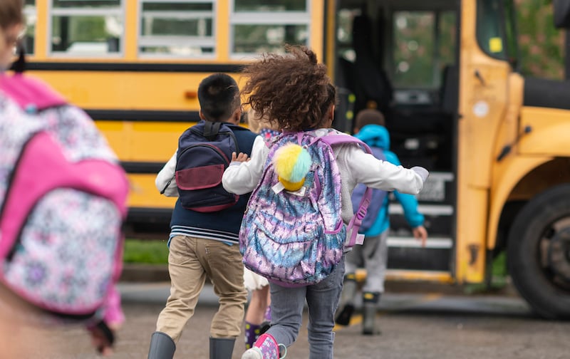 Diverse Group Of Happy Children Getting On School Bus