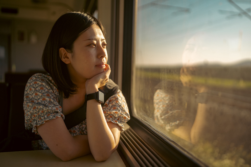 Portrait Of Young Female Tourist Traveling By Train