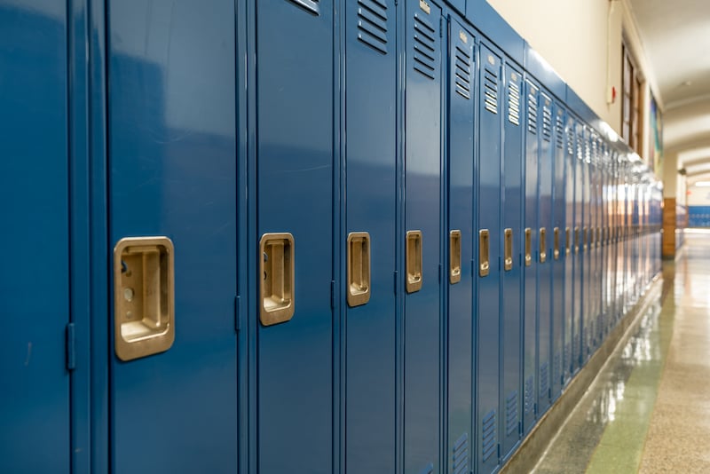 Photo Of A Blue Metal Lockers Along A Nondescript Hallway In A Typical Us High School. No Identifiable Information Included And Nobody In The Hall.