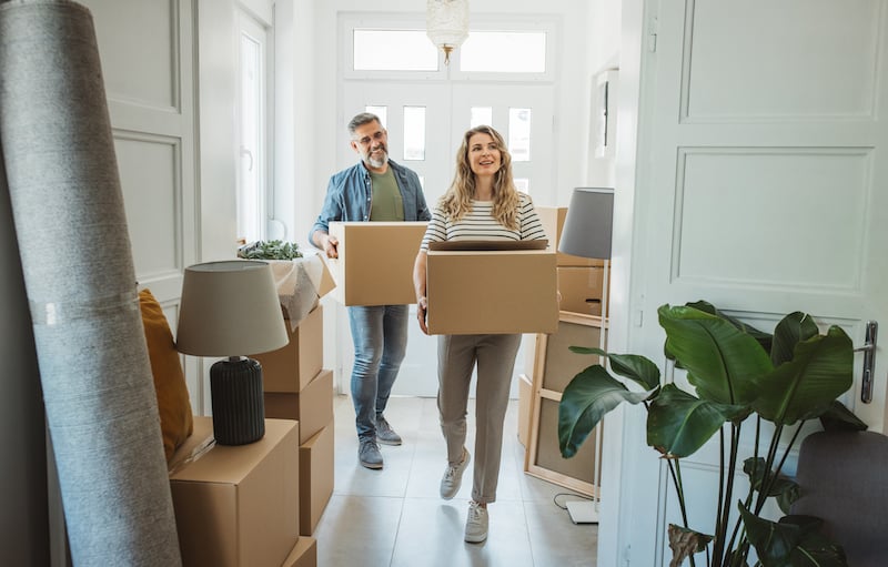 Mature Couple With Moving Boxes In New Home