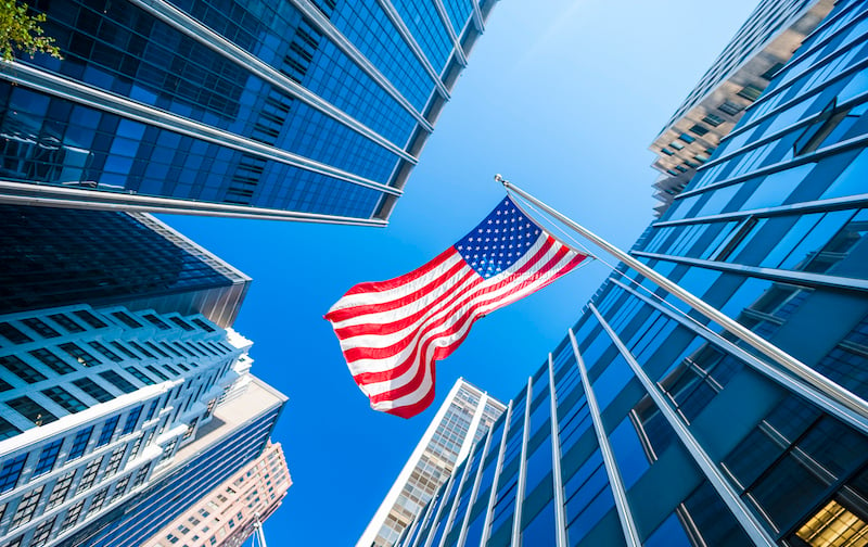 Usa Flag And Contemporary Glass Skyscrapers In New York