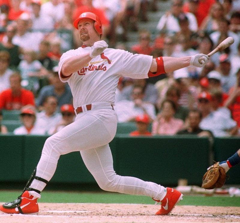 St. Louis Cardinals hitting coach Mark McGwire holds a bat in the