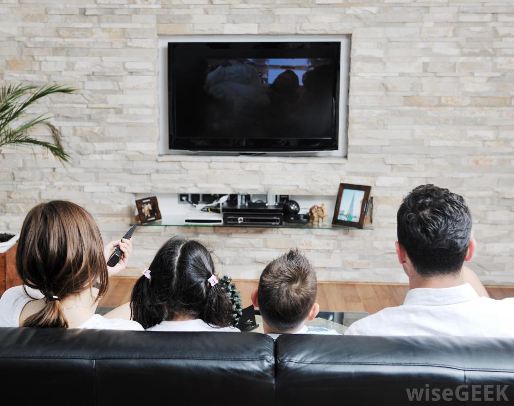 Family On Couch Watching Television