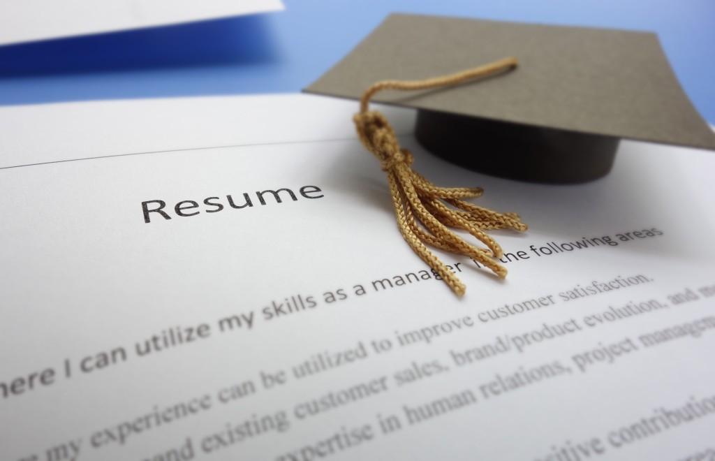 Job,applicant,resume,and,graduation,cap