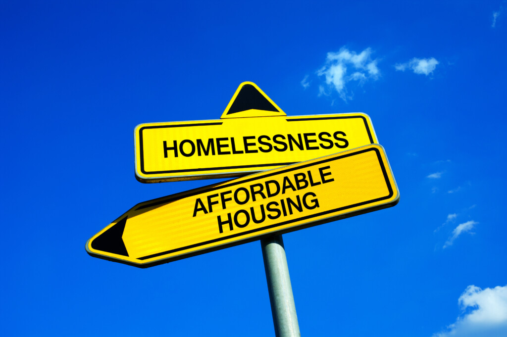 The Economics of Homelessness Vs Affordable Housing Traffic Sign With Two Optio