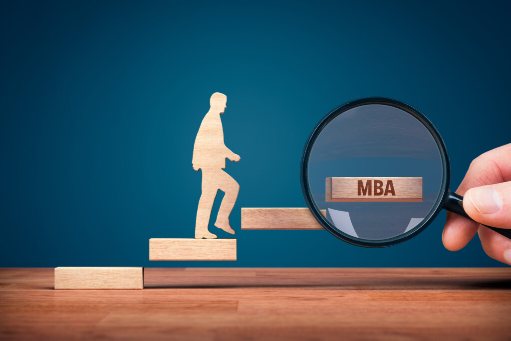 Do I need an MBA? Hand with loupe and person made from wood and wooden stairs leading to an MBA.
