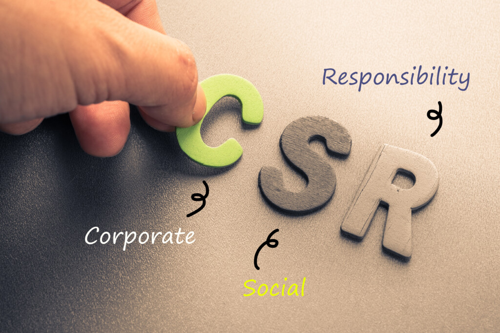 Corporate Social Responsibility Concept: Closeup hand arrange wood letters as CSR abbreviation(Corporate social responsibility)