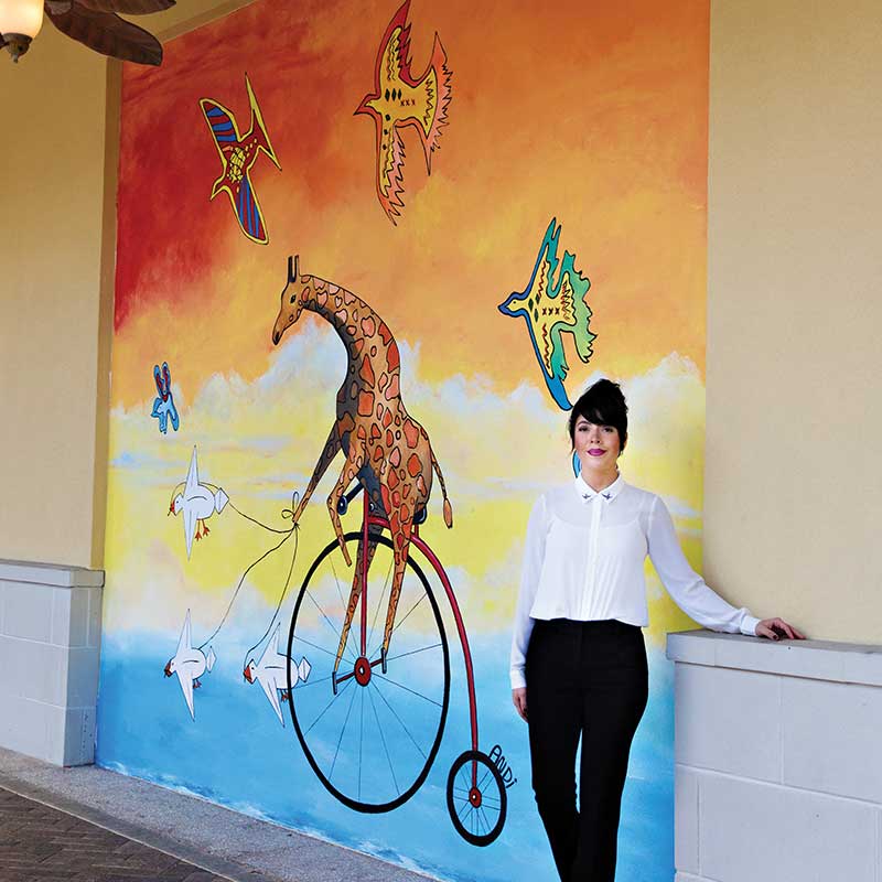 Andi Scurto with her Giraffe Mural