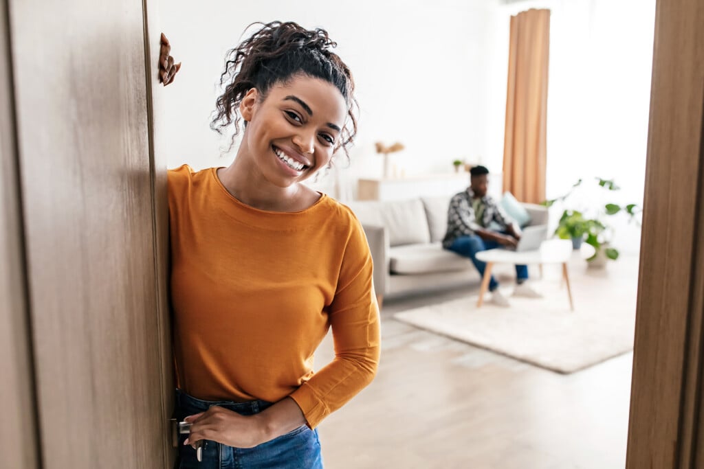 Cheerful Black Wife Meeting You Smiling Standing In New Apartment