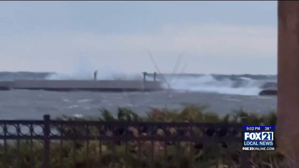 Waves Crash On Sightseers Before One Gets Pulled In