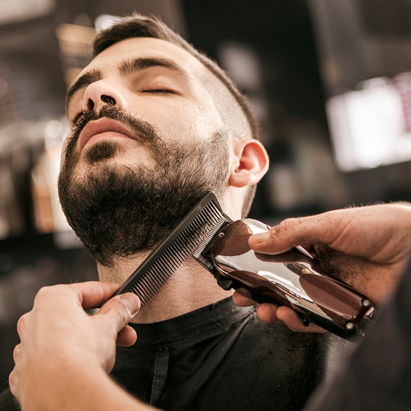 Man Getting His Beard Trimmed With Electric Razor