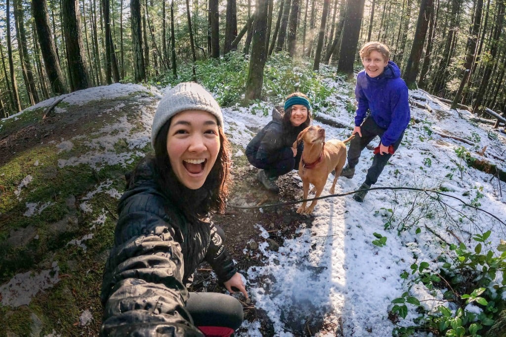 Multi Ethnic Family, Friends, Vizsla Dog Posing For Winter Hiking Selfie