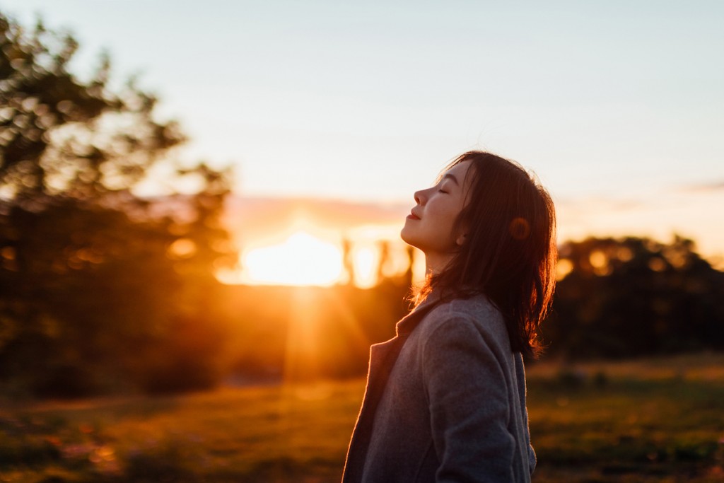 Young Woman Taking A Breath Of Fresh Air In Nature