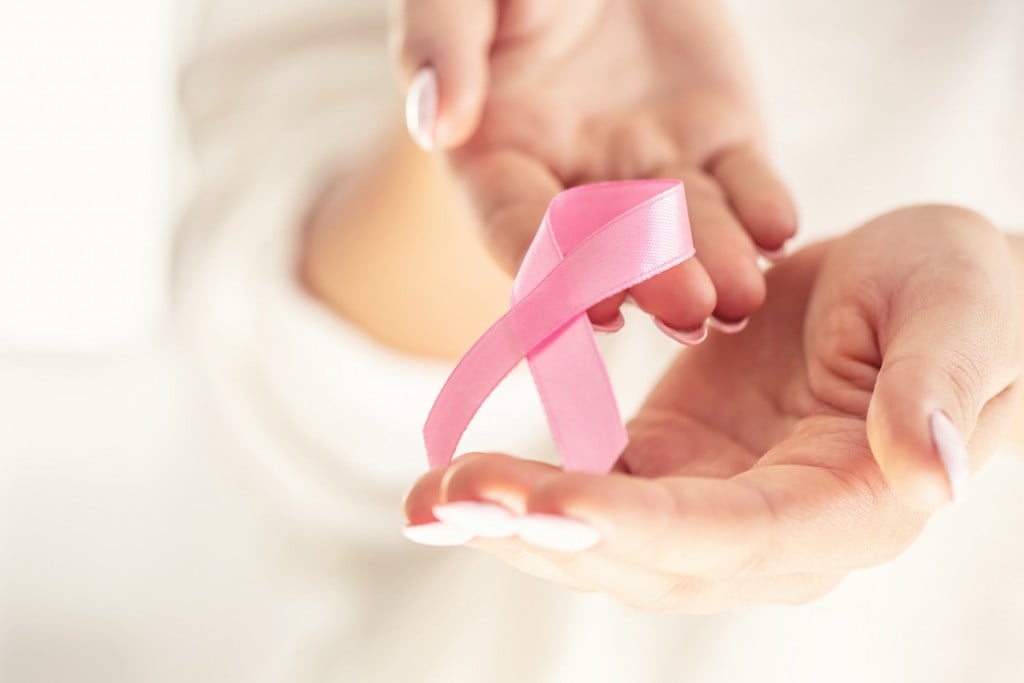 Breast Cancer Symbol Pink Ribbon In Tender Female Hands. October Health And Medicine Concept.