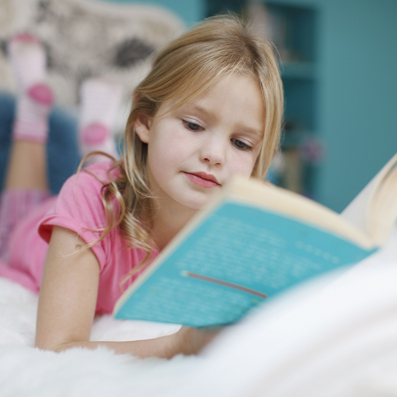 Girl Laying On Bed Reading Book