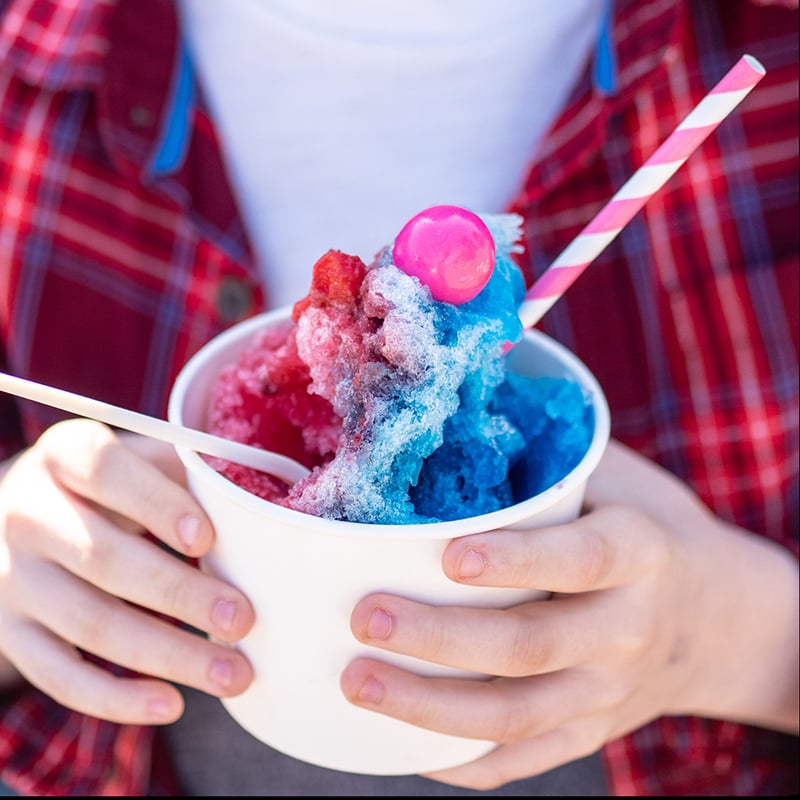 Detail Shot Of Young Person Holding Colorful Shave Ice
