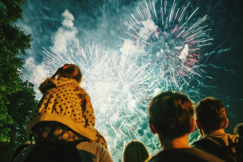 Low Angle View Of People Watching Firework Display
