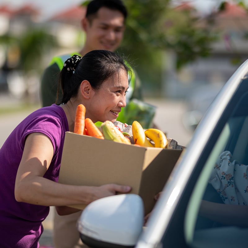 Volunteer Received Donation Food At Drive Through Food Bank