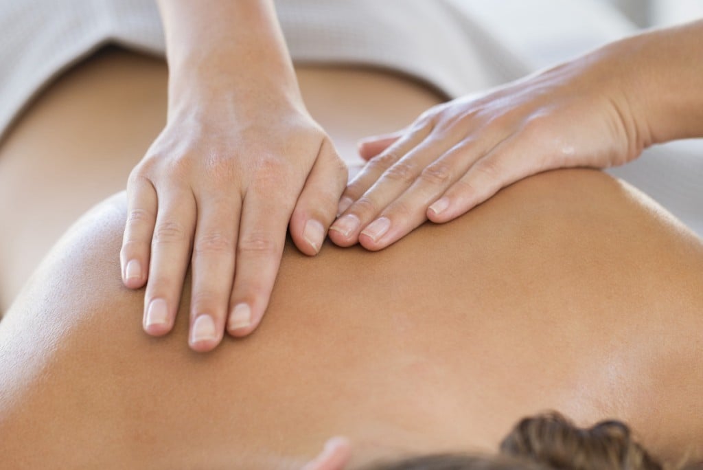 Woman Receiving Back Massage From A Massage Therapist