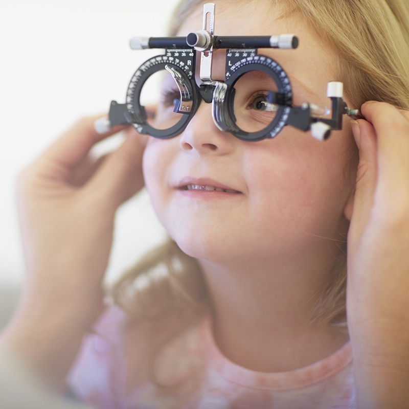 Eye Doctor Examining Girl's Vision