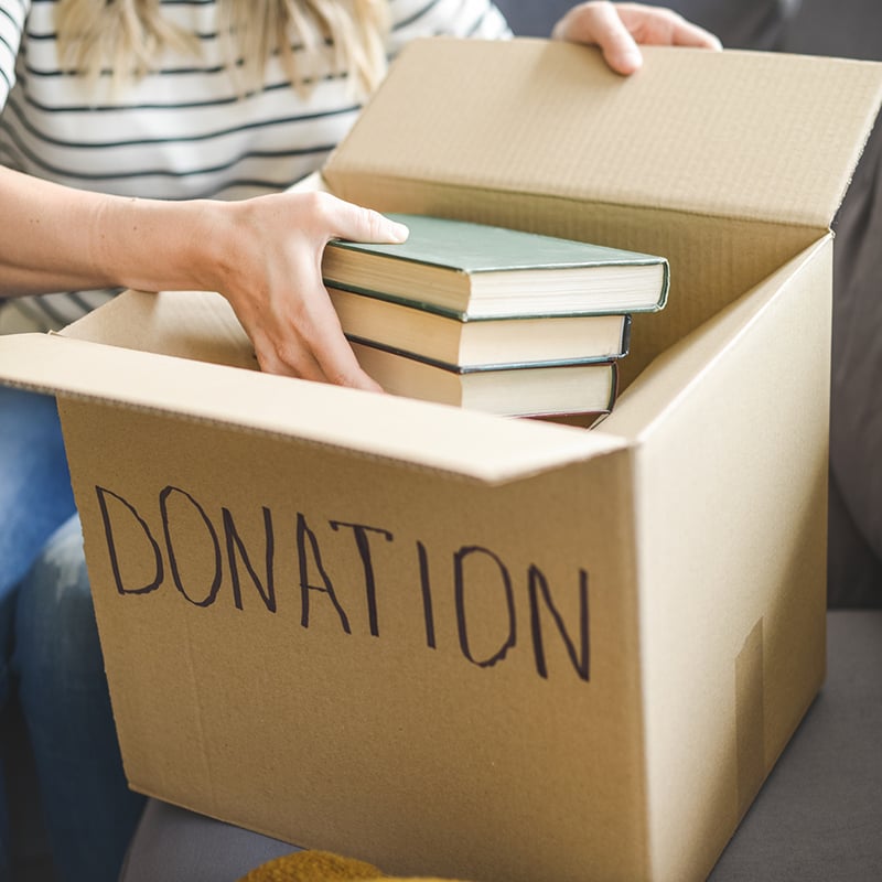Woman Puts Donations In A Box