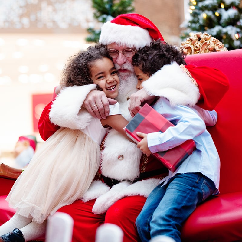 Shopping Christmas With Family And Santa Claus At Shopping Mall