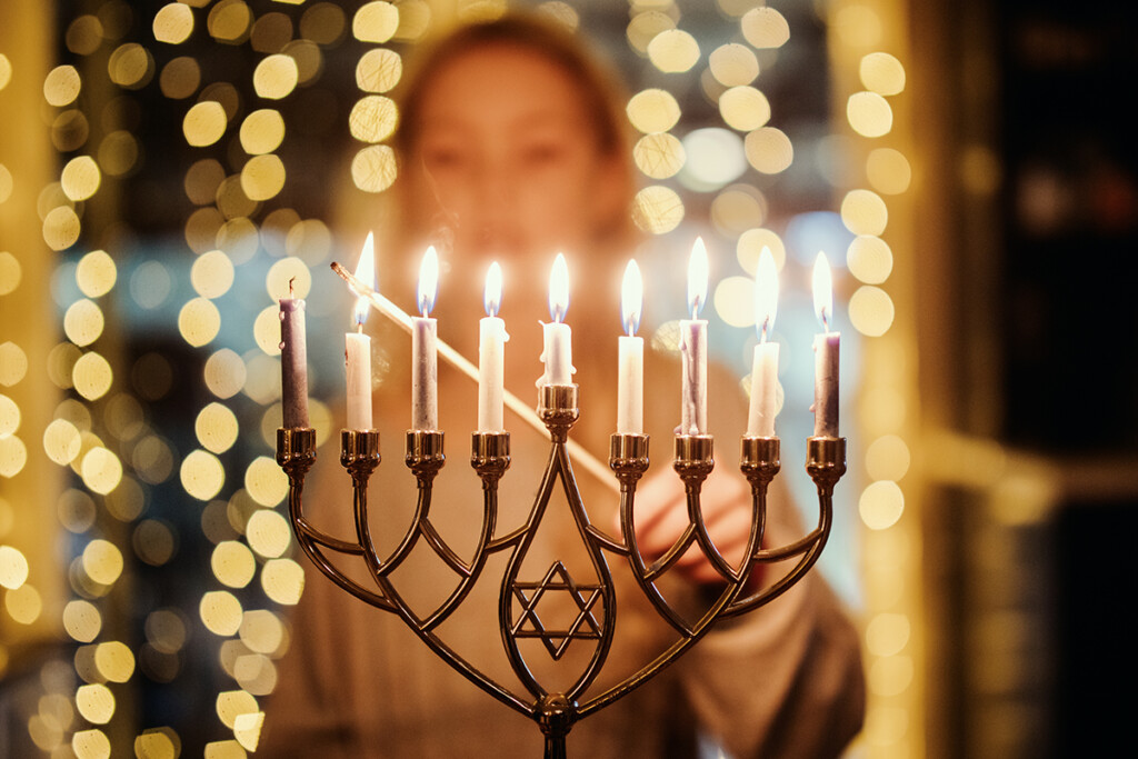 Girl Lighting Menorah For Hanukkah