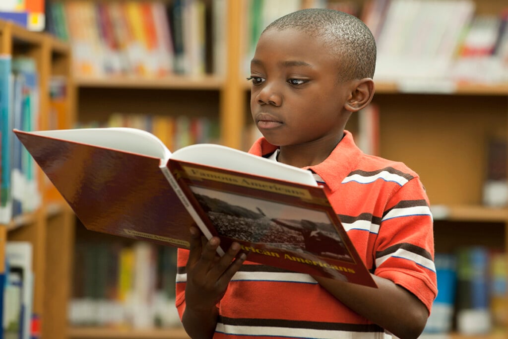 Black Boy Reading Book In Library