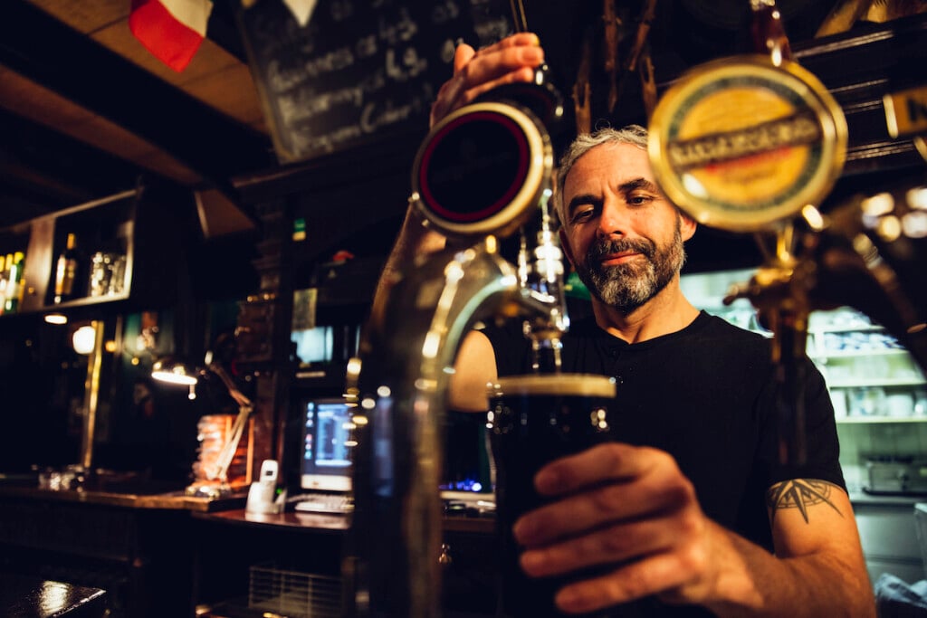 Man Tapping Beer In An Irish Pub