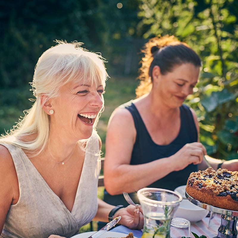 Mature Woman Laughing At Garden Party