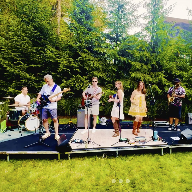 Image of a band playing on an outdoor stage