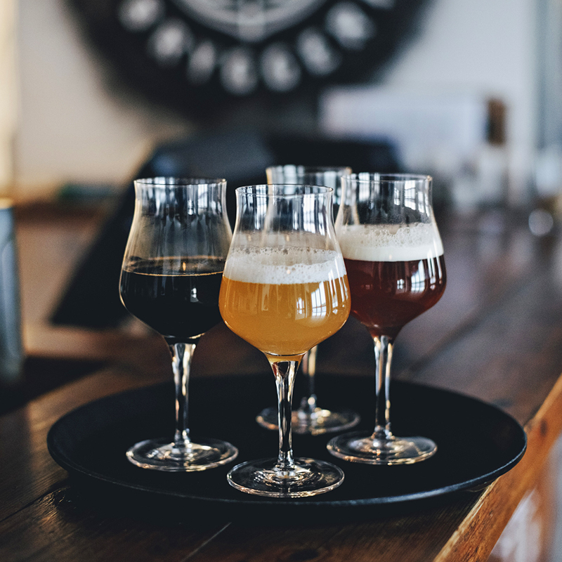 Craft beers and malts in glasses on a serving tray