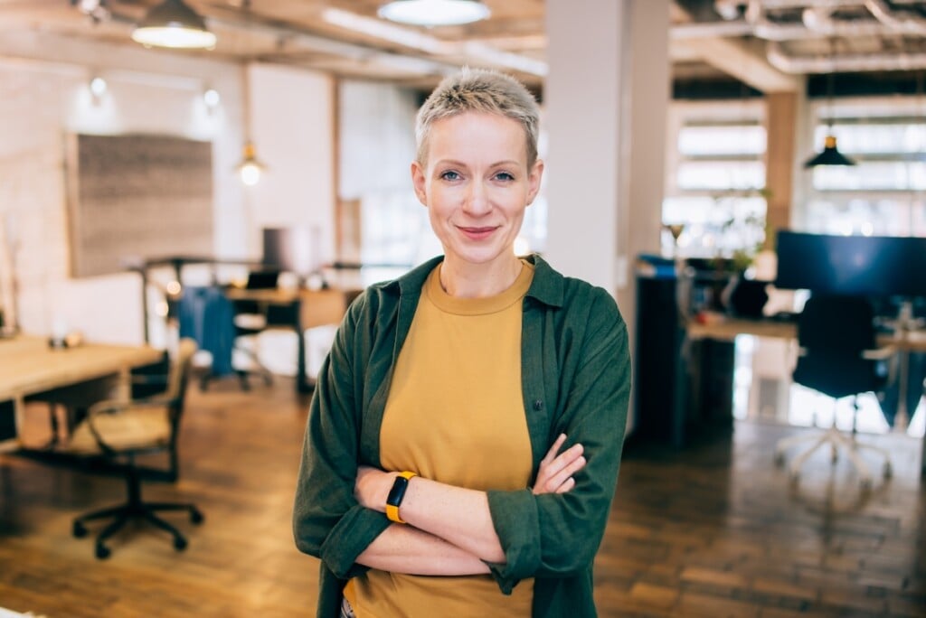 Confident Smiling Businesswoman Standing In A Coworking Space.