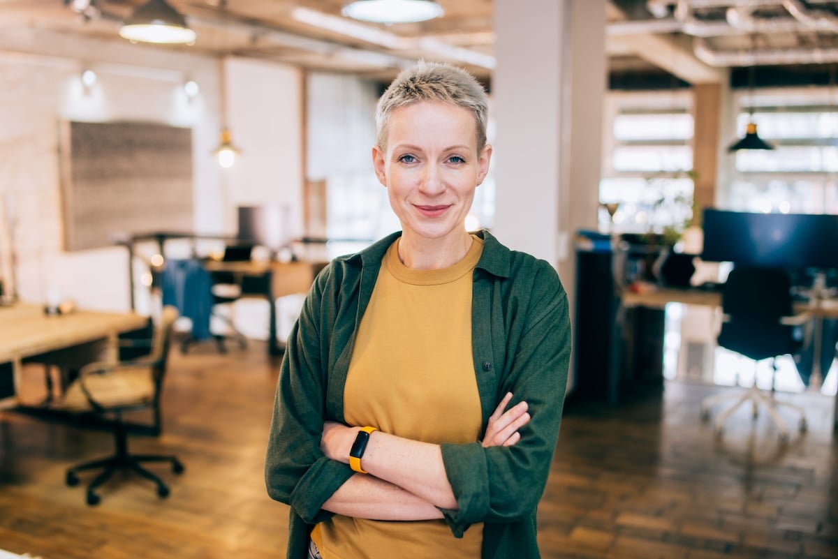 Confident Smiling Businesswoman Standing In A Coworking Space.