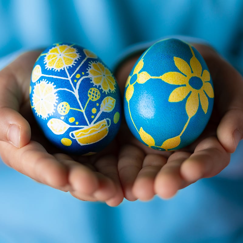 Obscured Little Girl Holding Colorful Easter Eggs Painted In Blue And Yellow With Ukrainian National Symbols