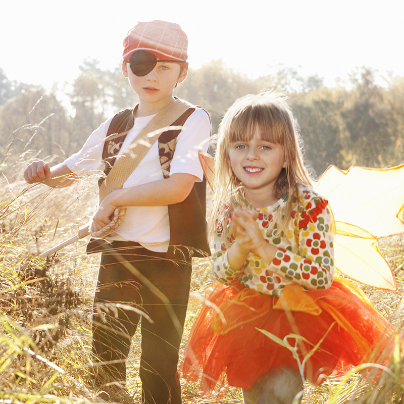 Children Playing Dress Up In Wheatfield