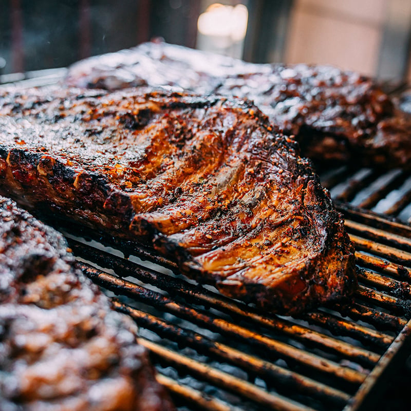 Close Up Shot Of Slow Cooked Beef Ribs On The Grill At An Argentine Asado
