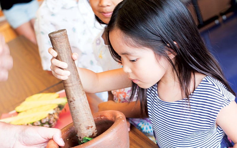 Child making pesto